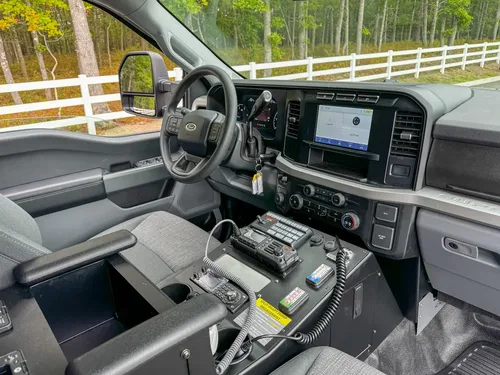 Dashboard center-stack close-up with infotainment screen and climate controls.